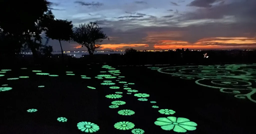 Fluorescent flower patterns glowing on the stone floor during sunset at Wat Sirindhorn Wararam in Ubon Ratchathani Province, Isaan.