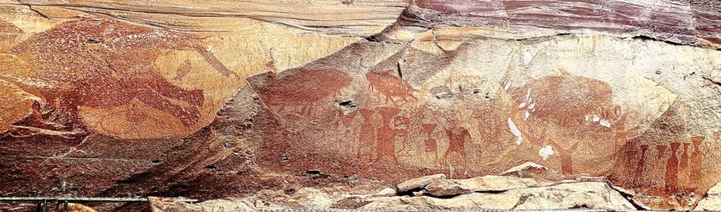 Ancient prehistoric red ochre rock paintings on the historic sandstone cliffs at Pha Taem National Park in Ubon Ratchathani Province, Isaan.