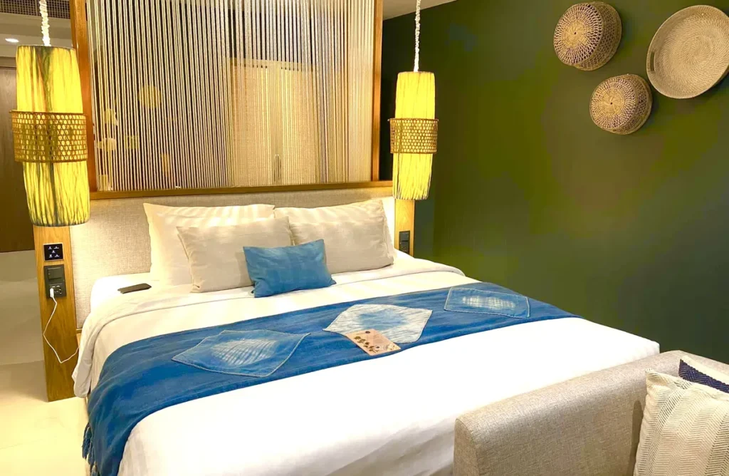 A bright luxury hotel room with traditional design and warm lighting at Tohsang Heritage Khongjiam.