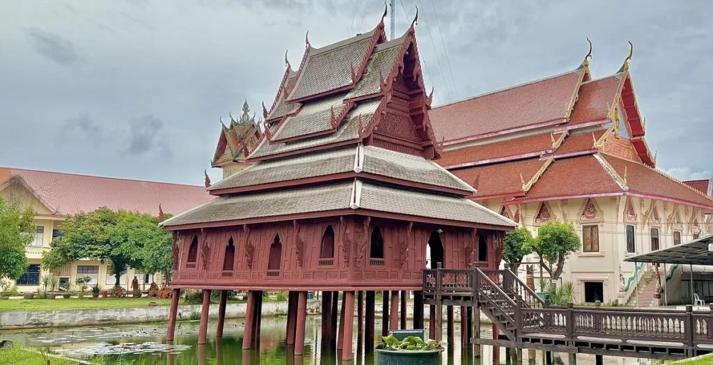 The historic wooden Ho Trai library built on stilts over a pond at Wat Thung Si Mueang temple in Ubon Ratchathani, Isaan.