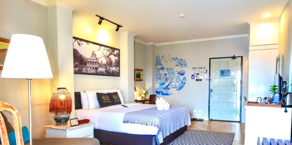The bright Vincent van Gogh themed room with custom blue wall art at Yuu Hotel Ubon Ratchathani.